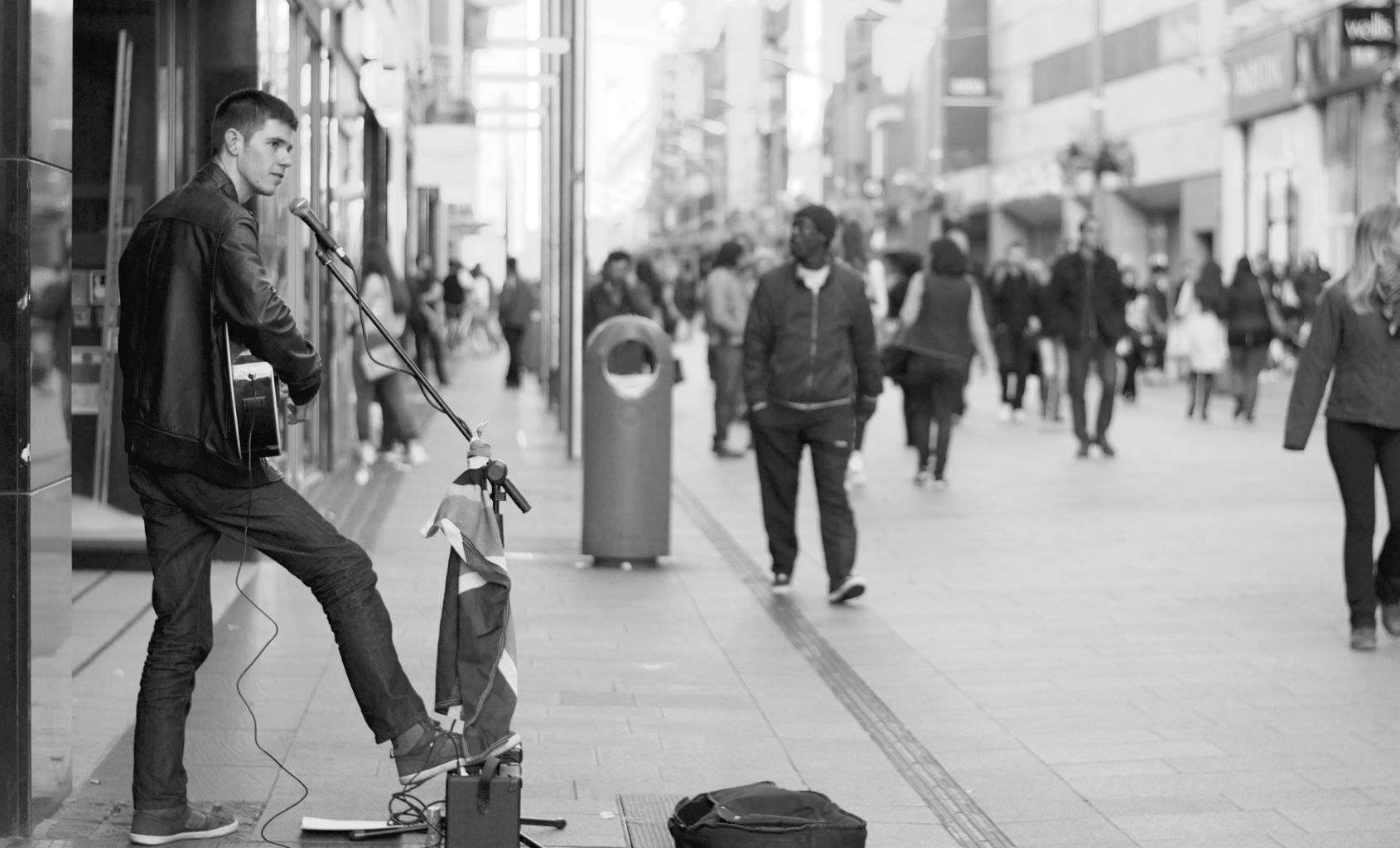 Busker playing an Akustix guitar to passersby