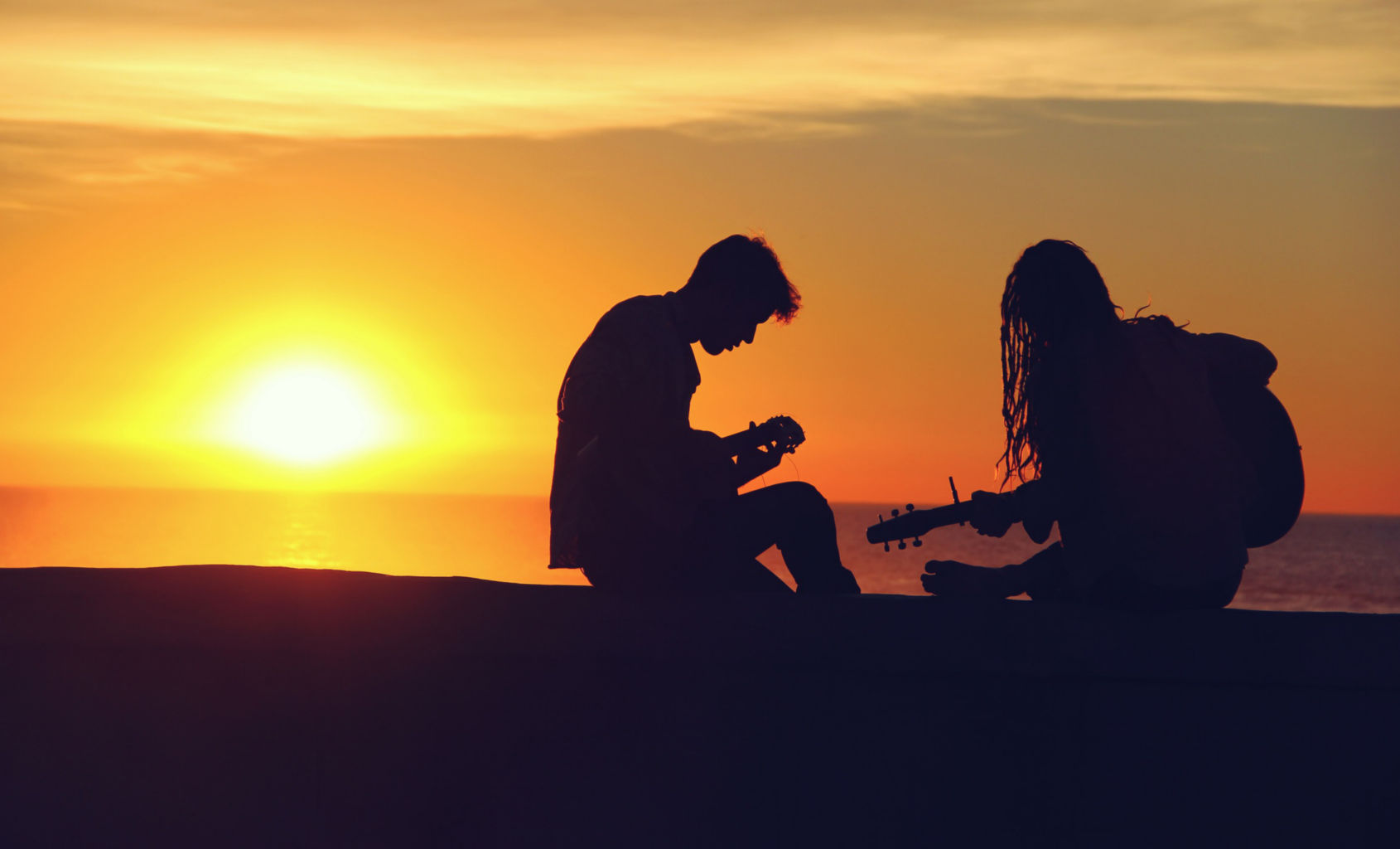 Men jamming at sundown with their Akustix